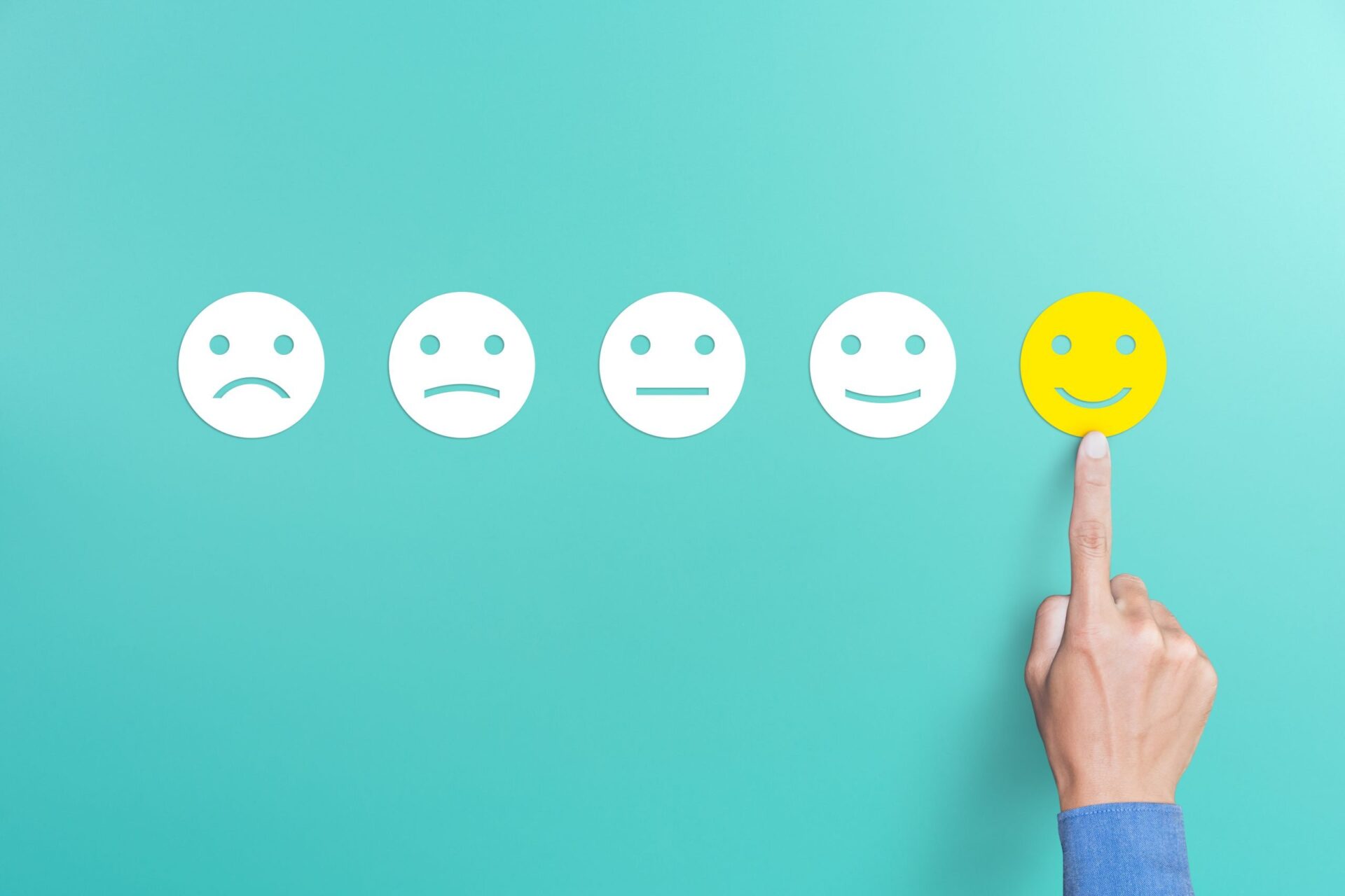 Photo of a line of faces progressing from sad to happy