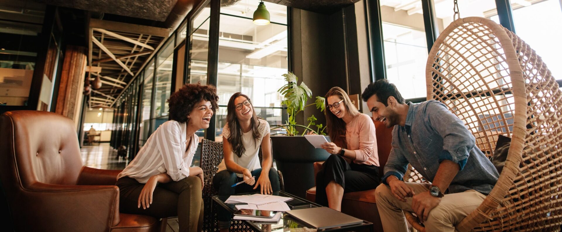 Photo of a group of people laughing and working