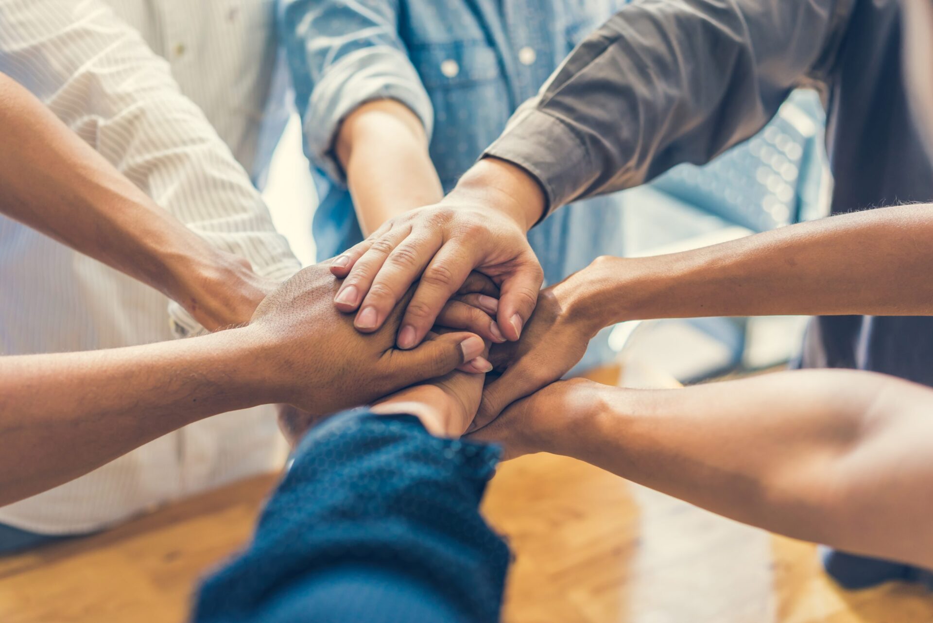 Photo of people putting their hands together