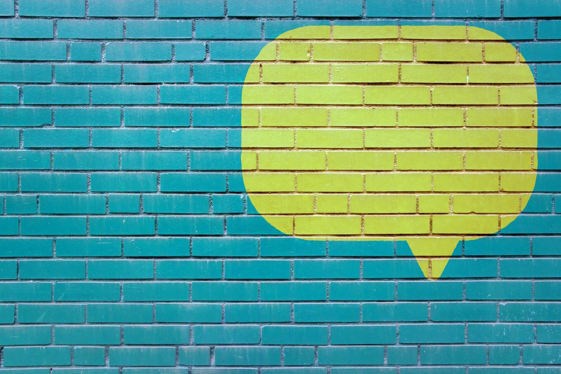photo of painted speech bubble on brick wall