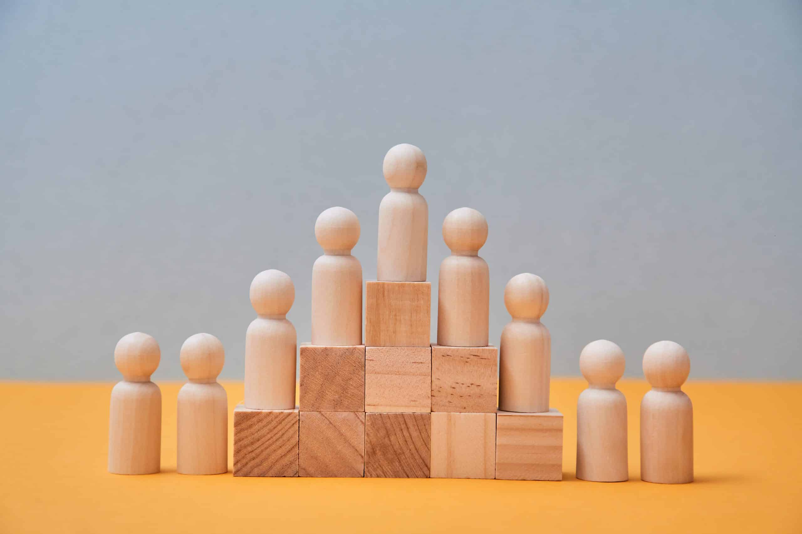 Photo of wooden peg people representing an organisation