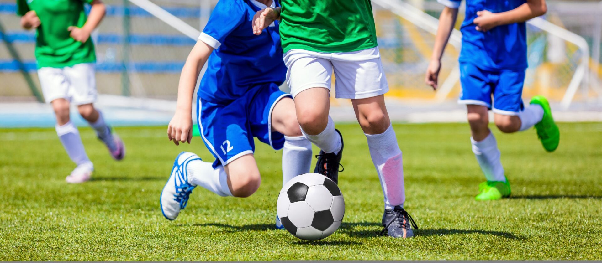 Photo of people kicking a football