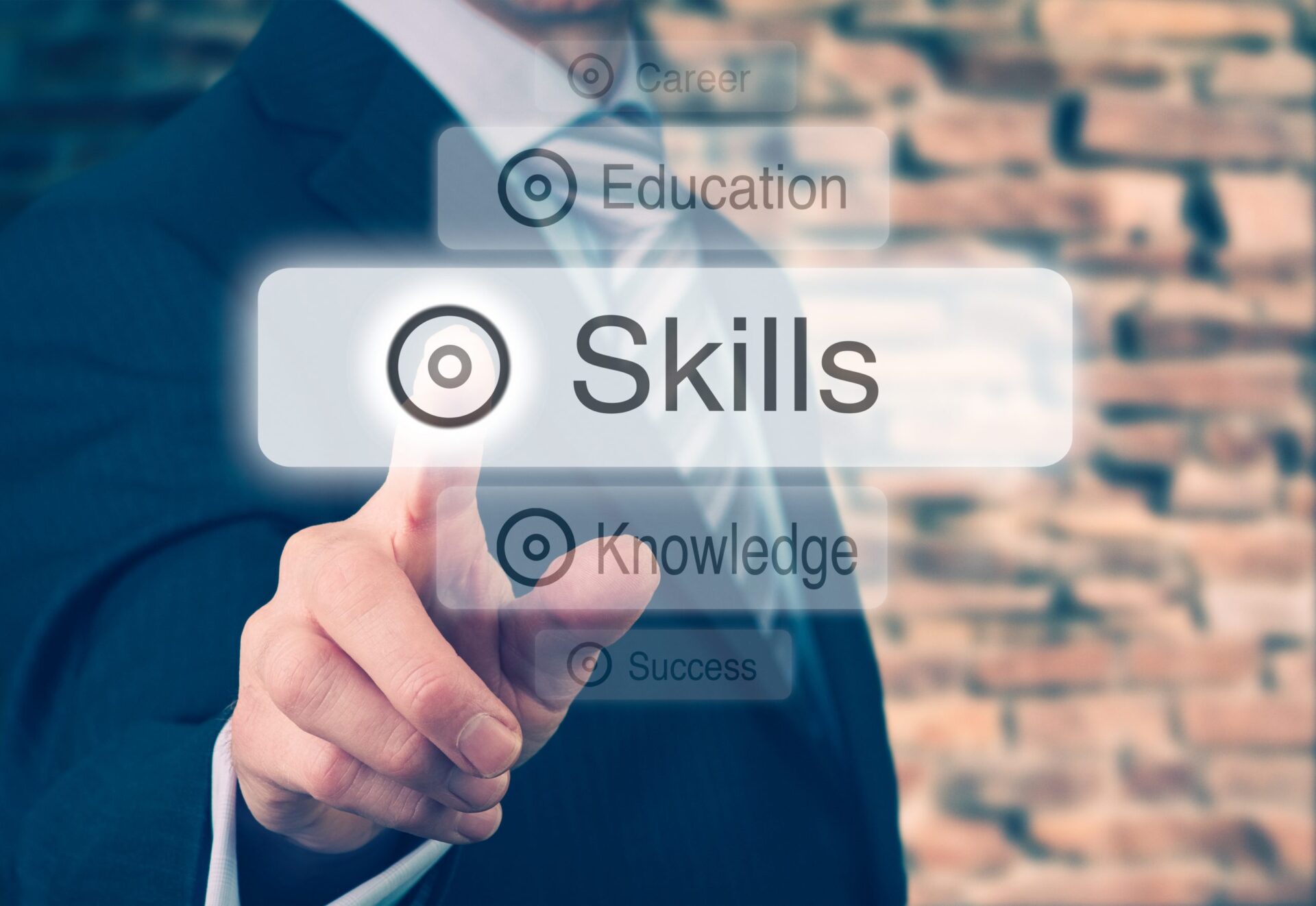 Photo of a man selecting the word 'skills' with his finger as if the photo is touch screen
