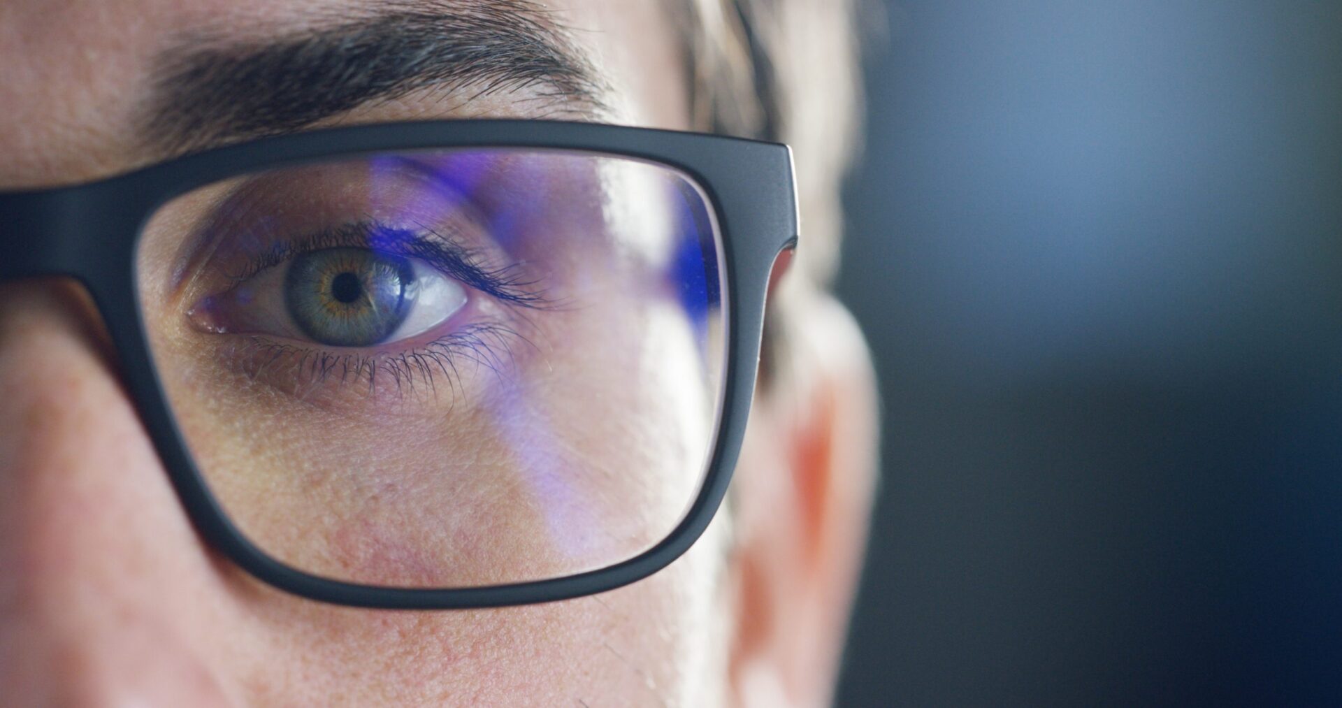 Photo of a close up of someones eye and glasses