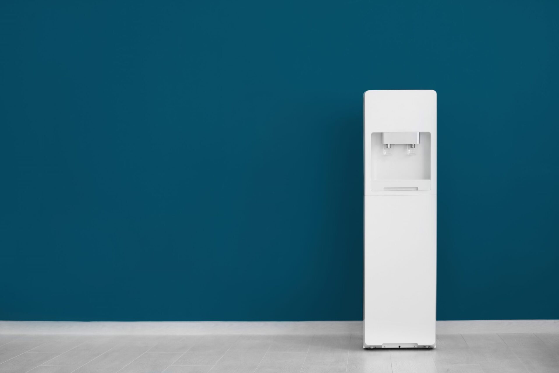 Photo of a group of people at work gathered around a water cooler