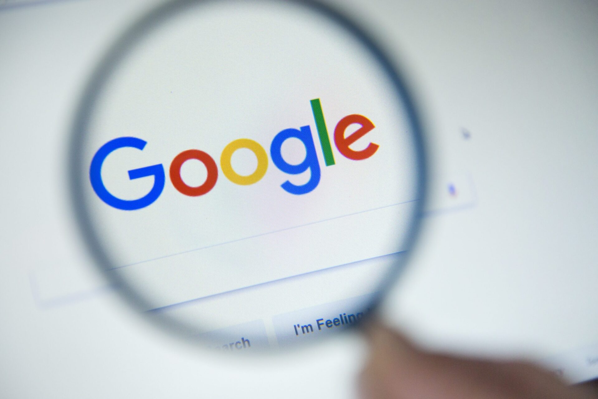 Photo looking through a magnifying glass looking at the word google