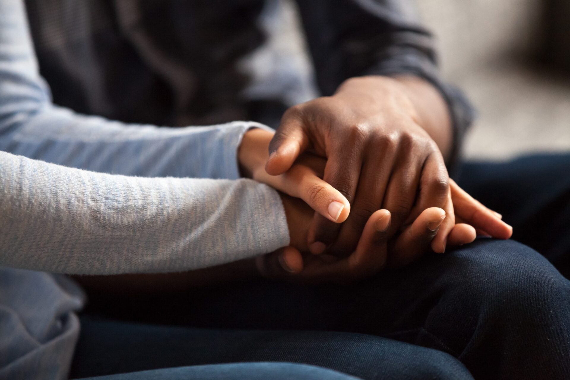 Photo of two people holding hands