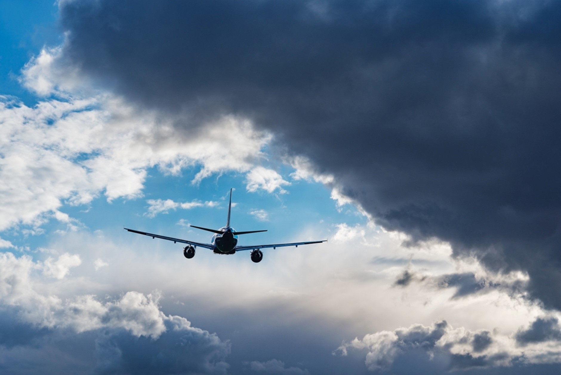 Airplane flying towards blue skies